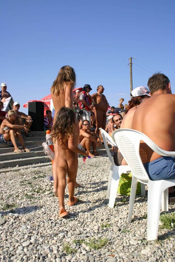 Naturist Standing Sideline - Minimizing clothing or nudism