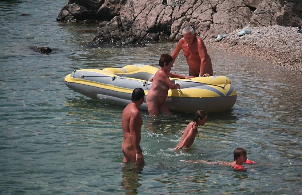 Lone Nudist in Yellow Boat photos - Nudism and naturism help overcome prejudices and fears related to physical appearance