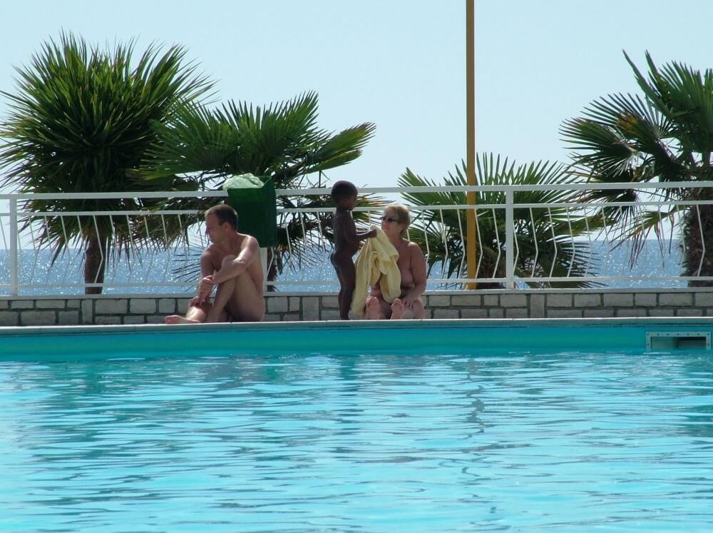 Photo of naturists in an outdoor pool - Spiritual and physical harmony are essential in nudist culture