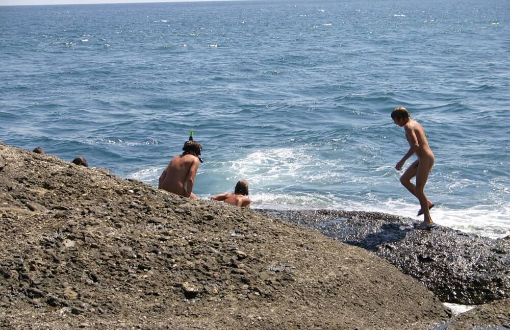 Leaning Against Hit Rocks pics - Social Nudism Around the World